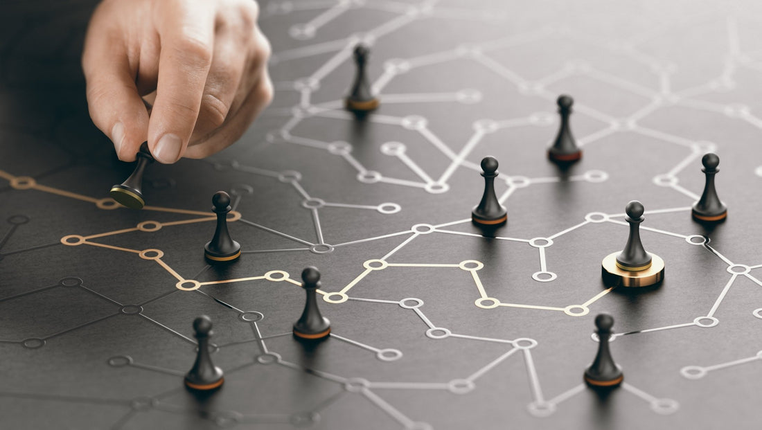 hand moving pieces strategically on a map