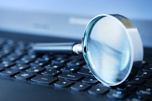 Magnifying glass on computer keyboard