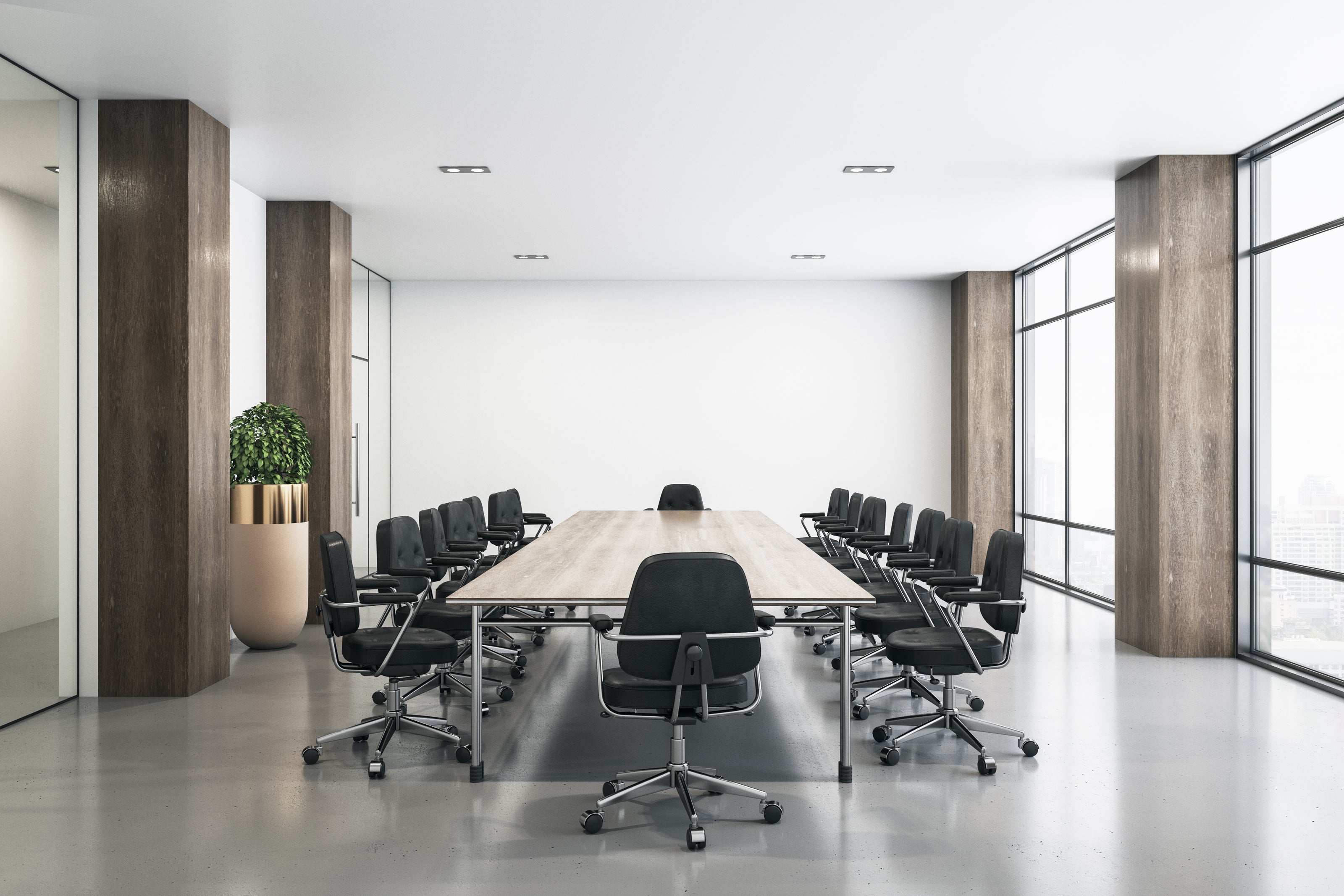 Modern conference room with a long table and chairs near large windows.